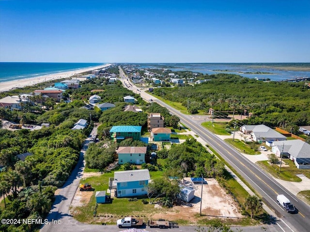 drone / aerial view with a beach view and a water view