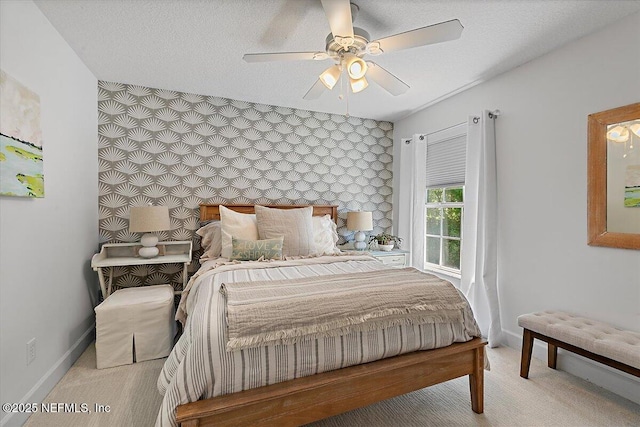 carpeted bedroom with baseboards and a ceiling fan