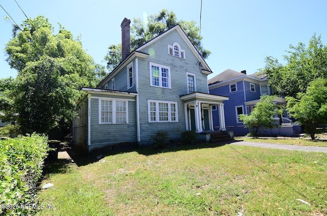 2138 Park St, Jacksonville, FL 32204 - view of front of property with a chimney and a front yard