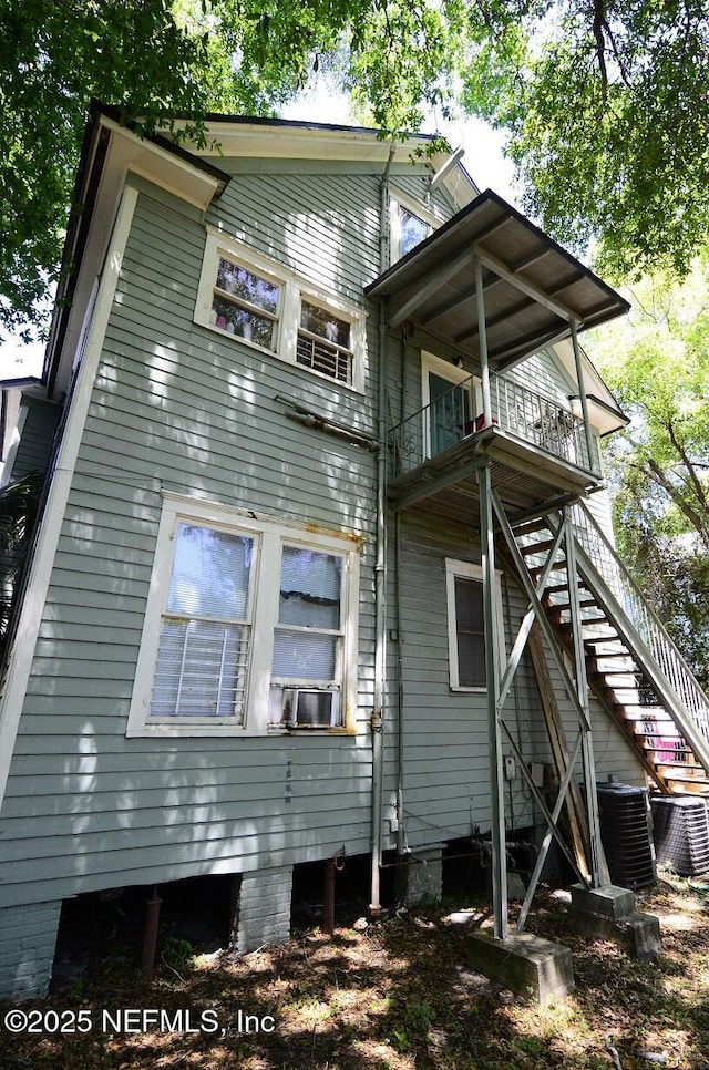 2138 Park St, Jacksonville, FL 32204 - rear view of property featuring cooling unit, central air condition unit, stairway, and a balcony