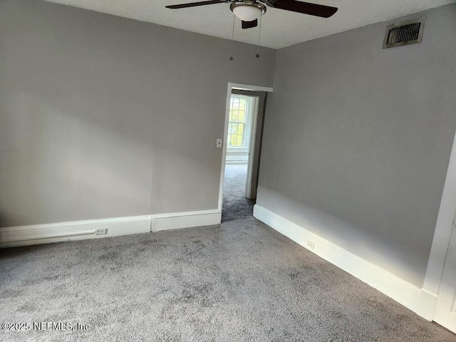 2138 Park St, Jacksonville, FL 32204 - spare room featuring carpet floors, a ceiling fan, visible vents, and baseboards