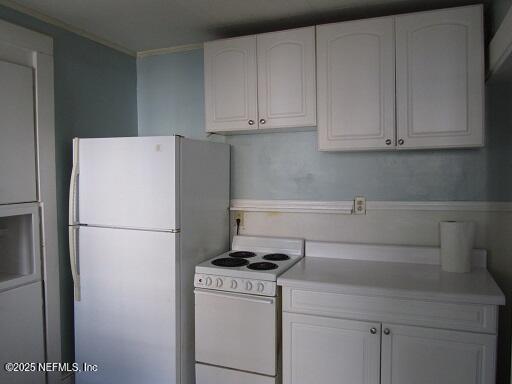 2138 Park St, Jacksonville, FL 32204 - kitchen featuring white cabinets, crown molding, white appliances, and light countertops
