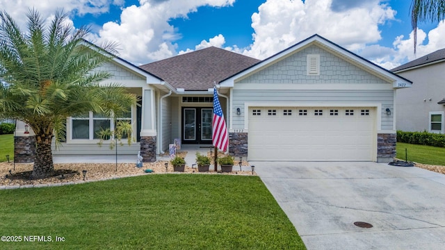 3422 Oglebay Dr, Green Cove Springs, FL 32043 - craftsman-style house featuring concrete driveway, a front lawn, stone siding, french doors, and a garage