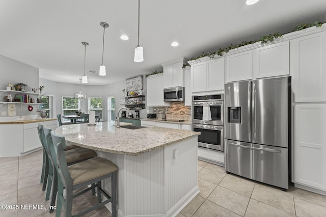 3422 Oglebay Dr, Green Cove Springs, FL 32043 - kitchen with open shelves, white cabinets, appliances with stainless steel finishes, and a sink