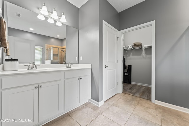 3422 Oglebay Dr, Green Cove Springs, FL 32043 - bathroom featuring a spacious closet, visible vents, a sink, and a shower stall
