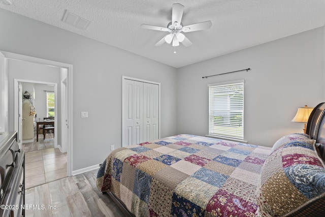 3422 Oglebay Dr, Green Cove Springs, FL 32043 - bedroom featuring visible vents, a closet, ceiling fan, light wood-style floors, and a textured ceiling