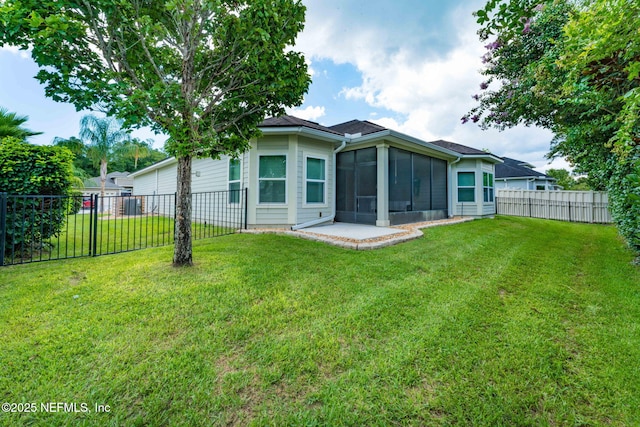 3422 Oglebay Dr, Green Cove Springs, FL 32043 - back of house featuring a fenced backyard, a sunroom, and a lawn