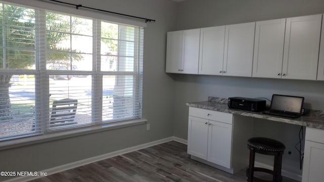 3422 Oglebay Dr, Green Cove Springs, FL 32043 - laundry room with wood finished floors, a healthy amount of sunlight, and baseboards