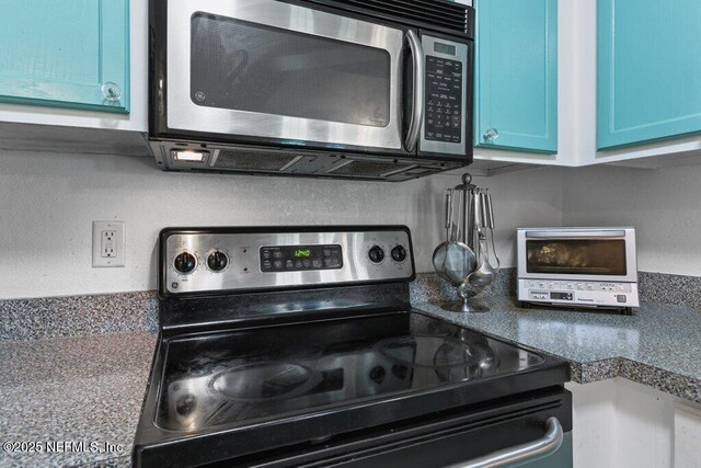 7800 Point Meadows Dr Unit 1035, Jacksonville, FL 32256 - kitchen view of appliances with stainless steel finishes and blue cabinetry