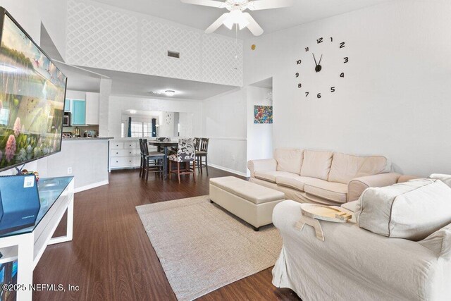 7800 Point Meadows Dr Unit 1035, Jacksonville, FL 32256 - living room with a high ceiling, dark wood-style flooring, ceiling fan, and baseboards