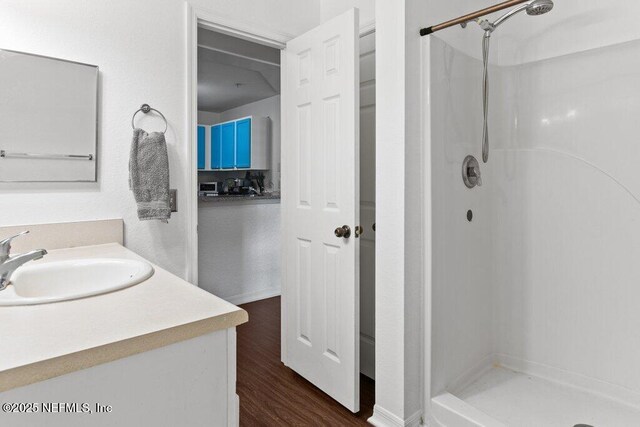 7800 Point Meadows Dr Unit 1035, Jacksonville, FL 32256 - bathroom featuring a shower stall, vanity, and wood finished floors