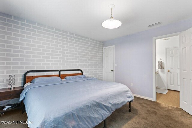 7800 Point Meadows Dr Unit 1035, Jacksonville, FL 32256 - bedroom featuring carpet floors, baseboards, and brick wall