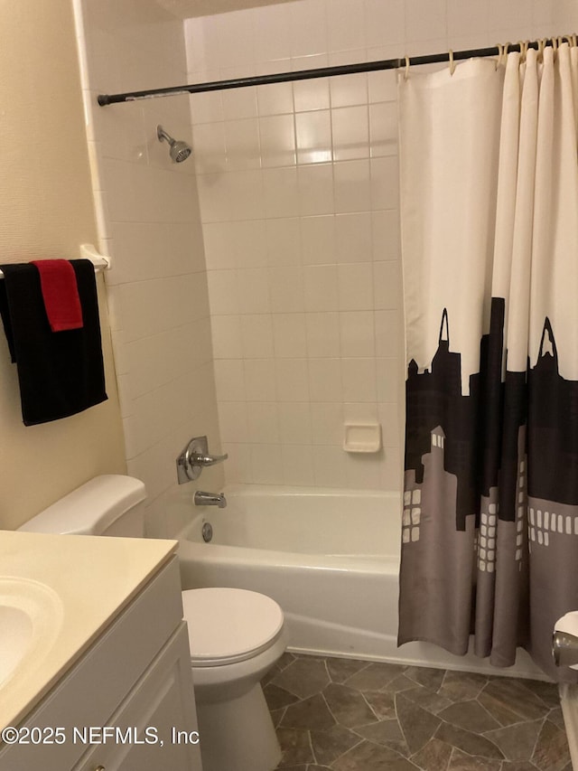 bathroom featuring shower / tub combo, toilet, and vanity