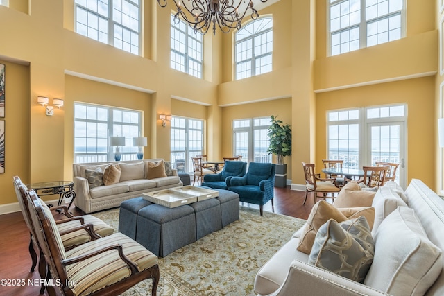 400 E Bay St Unit 502, Jacksonville, FL 32202 - living area with a chandelier, wood finished floors, a towering ceiling, and baseboards