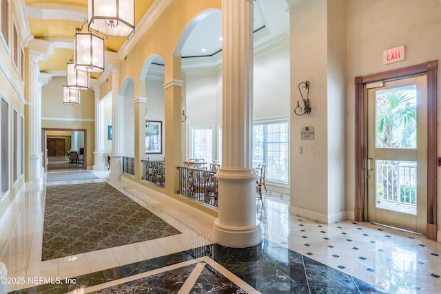400 E Bay St Unit 502, Jacksonville, FL 32202 - entryway featuring crown molding, a high ceiling, arched walkways, baseboards, and ornate columns