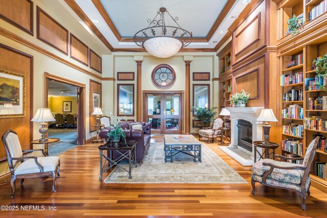 400 E Bay St Unit 502, Jacksonville, FL 32202 - living area with wood finished floors, a fireplace with raised hearth, a towering ceiling, and built in features
