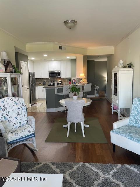 400 E Bay St Unit 502, Jacksonville, FL 32202 - living room with visible vents, wood finished floors, and ornamental molding