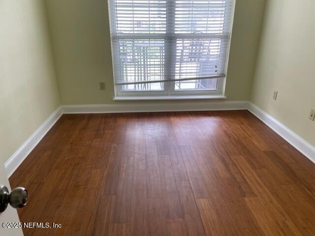 400 E Bay St Unit 502, Jacksonville, FL 32202 - spare room with baseboards and dark wood finished floors