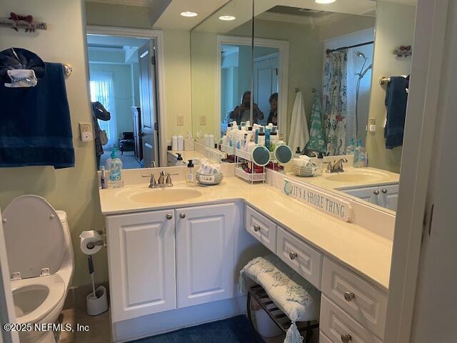 400 E Bay St Unit 502, Jacksonville, FL 32202 - bathroom with recessed lighting, double vanity, toilet, and a sink