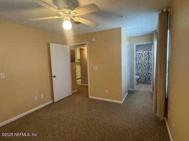 7701 Timberlin Park Blvd Unit 531, Jacksonville, FL 32256 - unfurnished bedroom with carpet flooring, attic access, baseboards, and ceiling fan