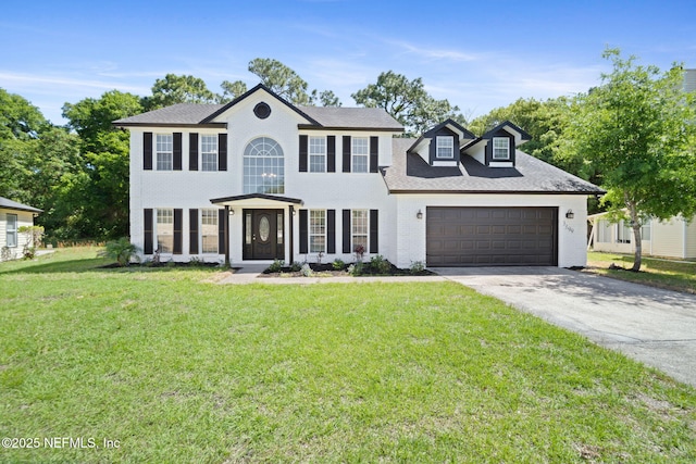 3399 Shauna Oaks Cir, Jacksonville, FL 32277 - colonial-style house featuring a garage, a front lawn, brick siding, and concrete driveway