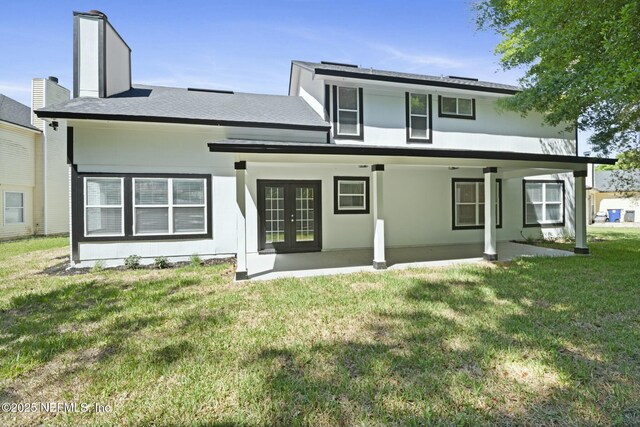 3399 Shauna Oaks Cir, Jacksonville, FL 32277 - back of property with french doors, a lawn, and a chimney