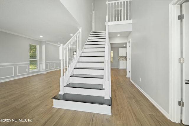 3399 Shauna Oaks Cir, Jacksonville, FL 32277 - staircase with recessed lighting, wood finished floors, ornamental molding, and wainscoting