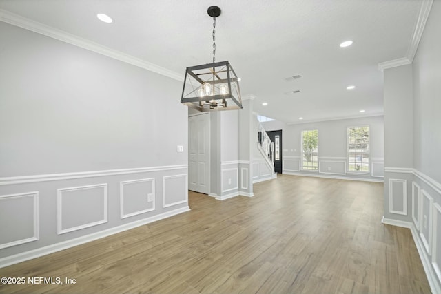 3399 Shauna Oaks Cir, Jacksonville, FL 32277 - unfurnished dining area with stairway, a decorative wall, wood finished floors, and an inviting chandelier