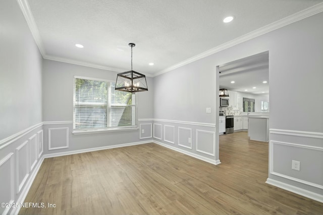 3399 Shauna Oaks Cir, Jacksonville, FL 32277 - unfurnished dining area featuring a decorative wall, ornamental molding, a notable chandelier, and wainscoting