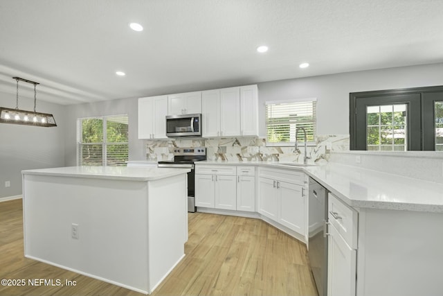 3399 Shauna Oaks Cir, Jacksonville, FL 32277 - kitchen featuring backsplash, light wood-style flooring, stainless steel appliances, and a sink