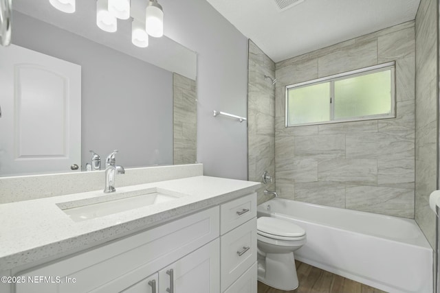 3399 Shauna Oaks Cir, Jacksonville, FL 32277 - bathroom with shower / bath combination, wood finished floors, vanity, and toilet