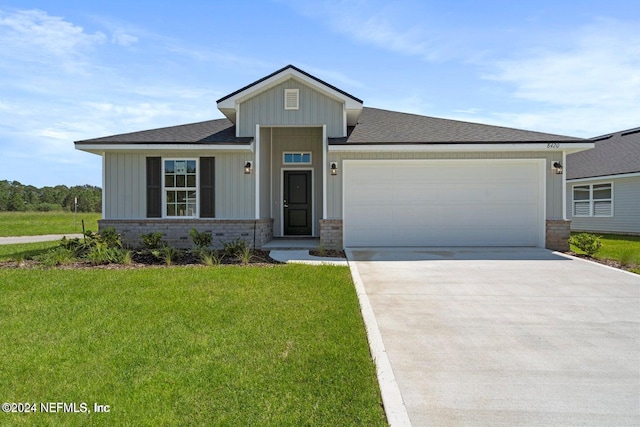 3211 Winding Creek Pl, Green Cove Springs, FL 32043 - view of front of home featuring concrete driveway, board and batten siding, an attached garage, a front lawn, and a shingled roof