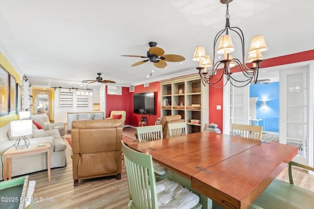 dining room with crown molding, light wood-style flooring, and ceiling fan with notable chandelier