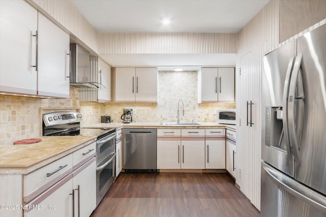 kitchen with a sink, light countertops, tasteful backsplash, and stainless steel appliances