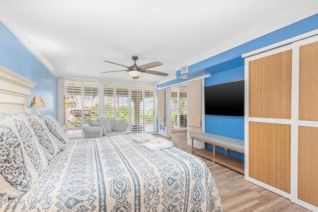 bedroom featuring ceiling fan, visible vents, crown molding, wood finished floors, and access to outside