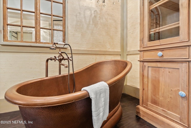 interior details featuring a freestanding tub and wood finished floors