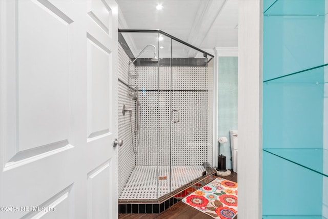 full bath featuring crown molding, a shower stall, and wood finished floors