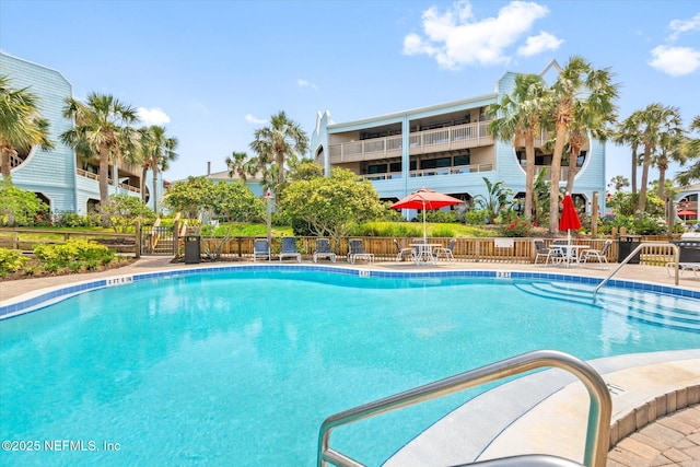 pool with fence and a patio
