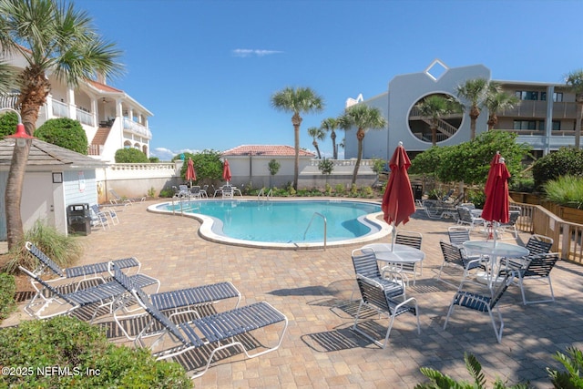 pool with fence and a patio area