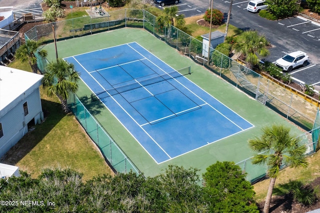 view of sport court featuring fence