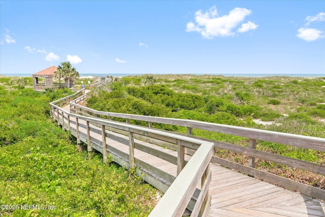 view of home's community with a deck with water view