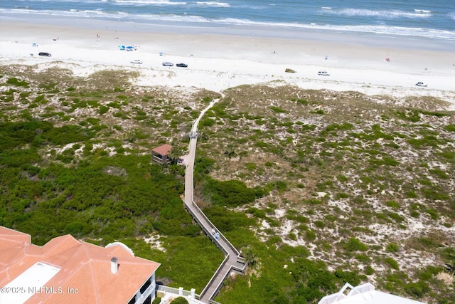 birds eye view of property featuring a water view and a view of the beach