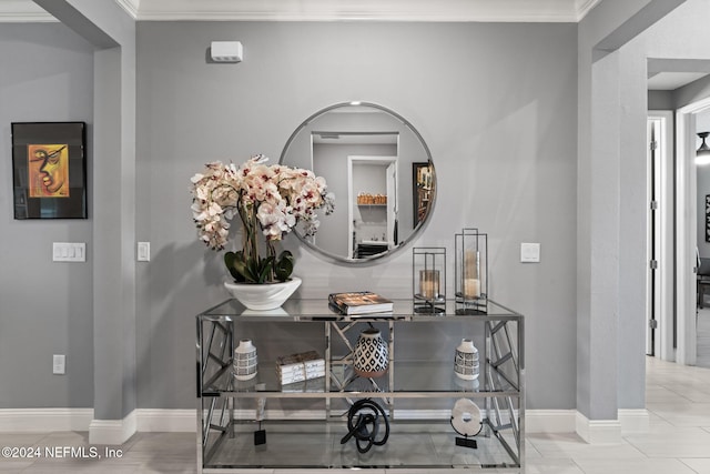 interior details with crown molding and baseboards
