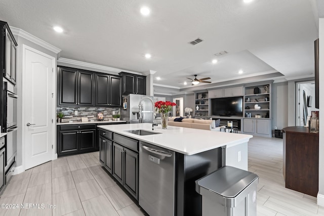 kitchen with stainless steel dishwasher, a sink, visible vents, ceiling fan, and crown molding