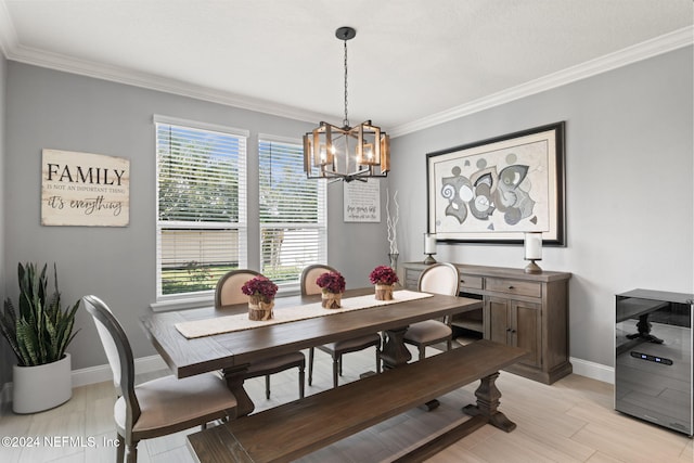 dining area with baseboards, a chandelier, and crown molding