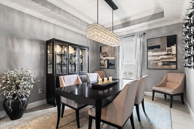 dining room with crown molding and baseboards