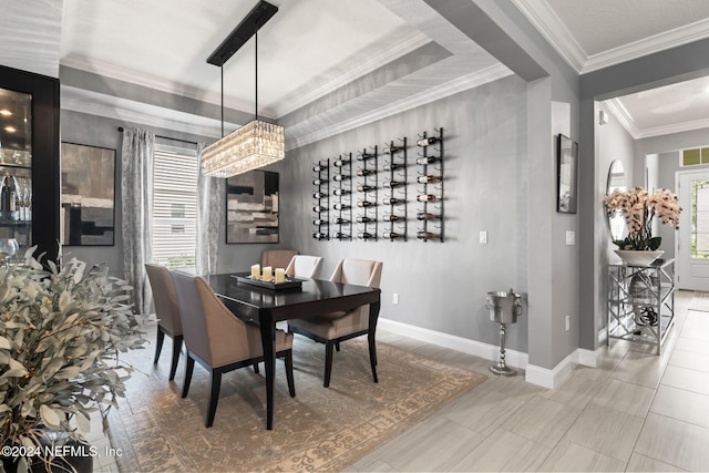 dining room featuring baseboards, ornamental molding, and a chandelier
