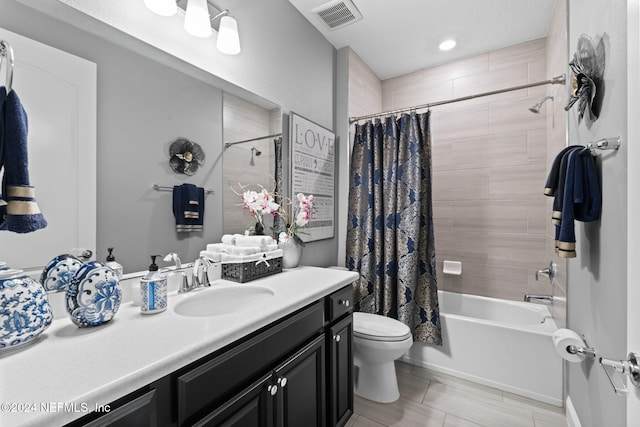 bathroom featuring shower / tub combo, toilet, vanity, and visible vents