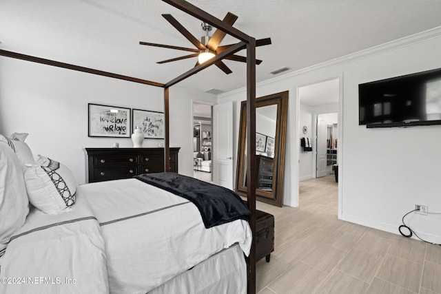 bedroom with baseboards, a ceiling fan, visible vents, and ornamental molding