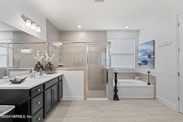 full bath with a garden tub, vanity, visible vents, and a stall shower